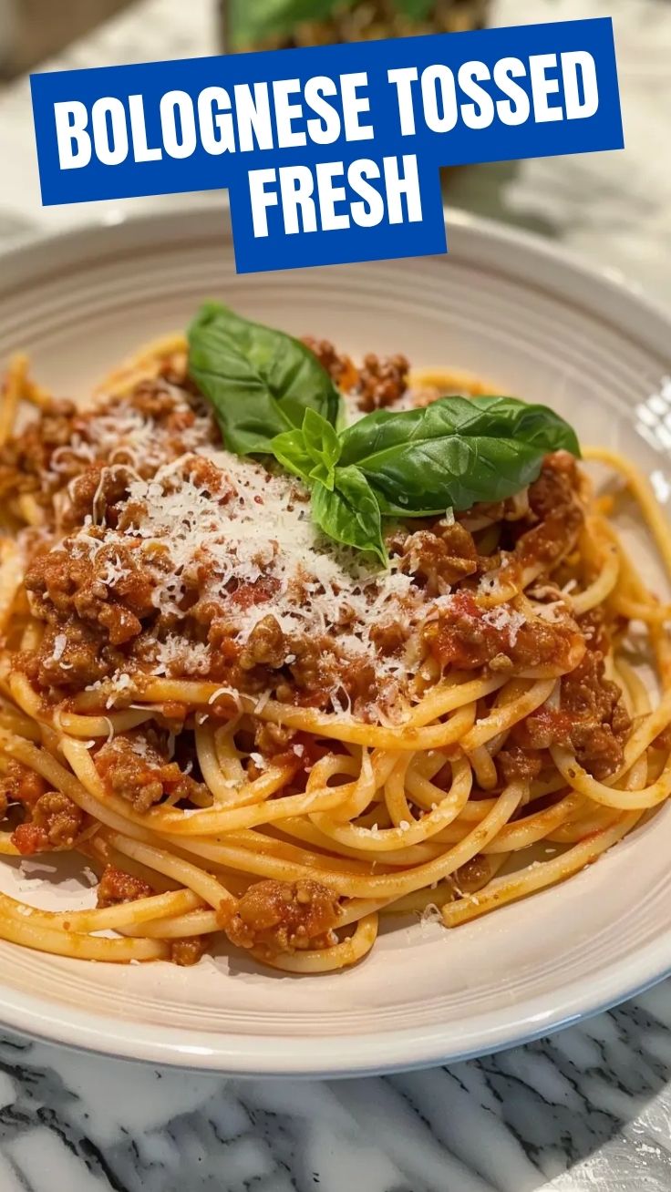 A steaming bowl of Spaghetti Bolognese garnished with fresh herbs.