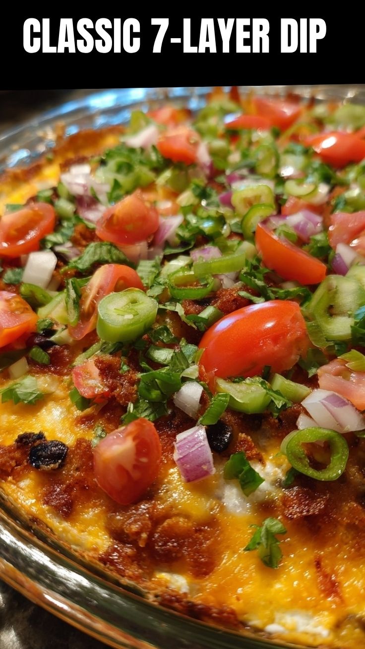 A vibrant 7-layer dip prepared in a clear glass dish, showing all colorful layers.