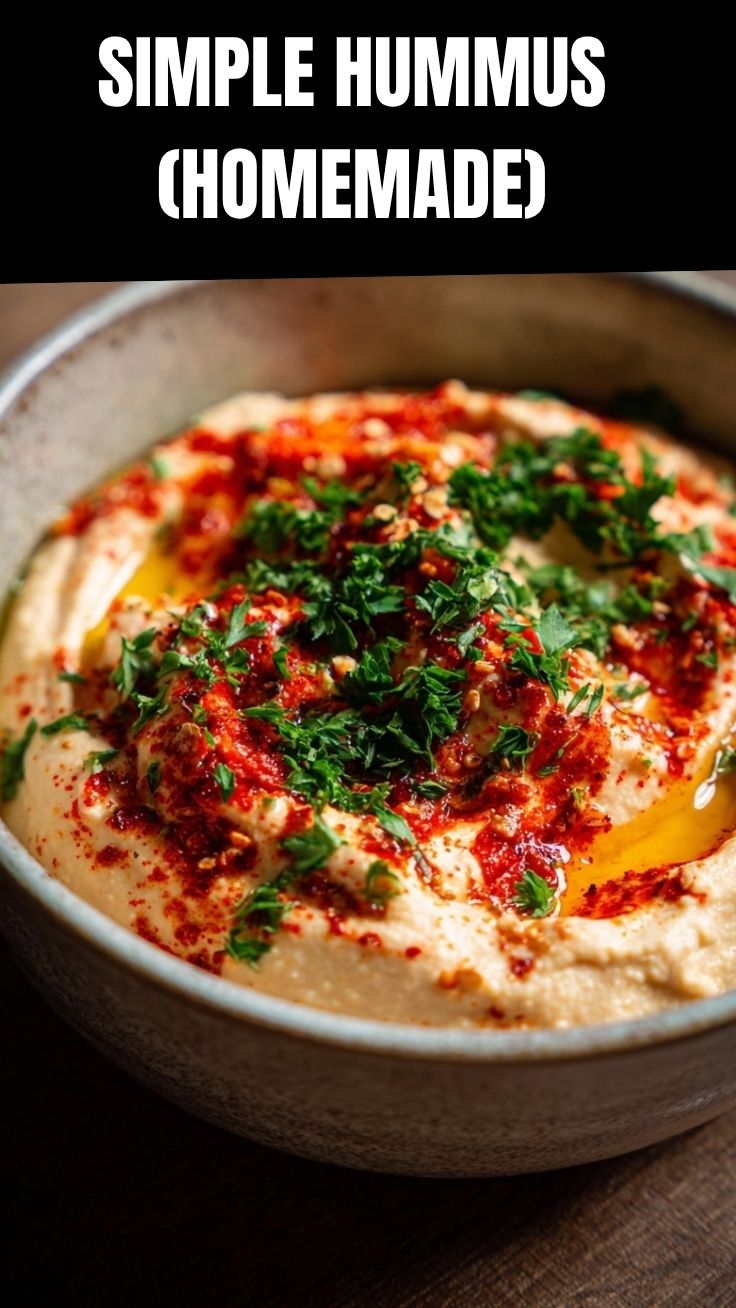 A vibrant bowl of homemade hummus, garnished with olive oil and parsley.