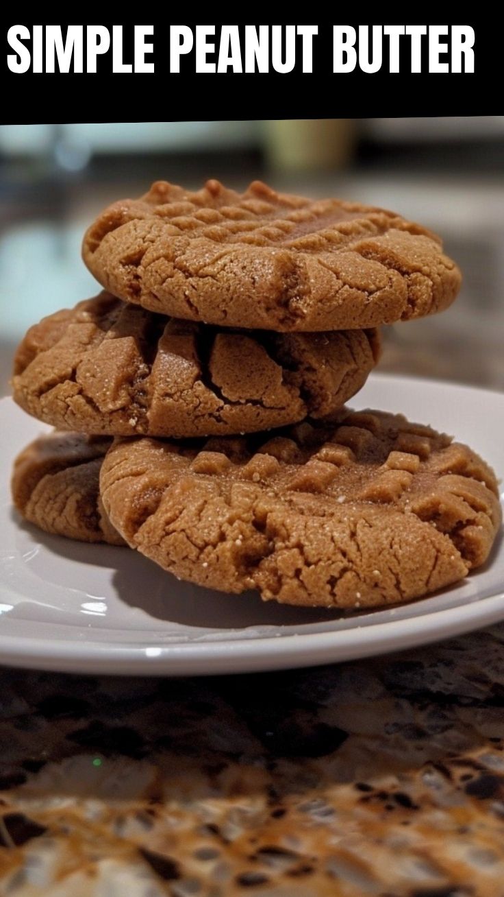 Freshly baked peanut butter cookies with fork marks on a cooling rack.