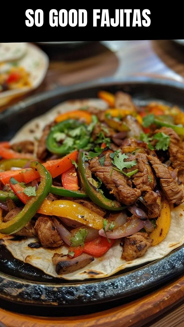 A sizzling platter of mixed chicken and beef fajitas with colorful peppers and onions.
