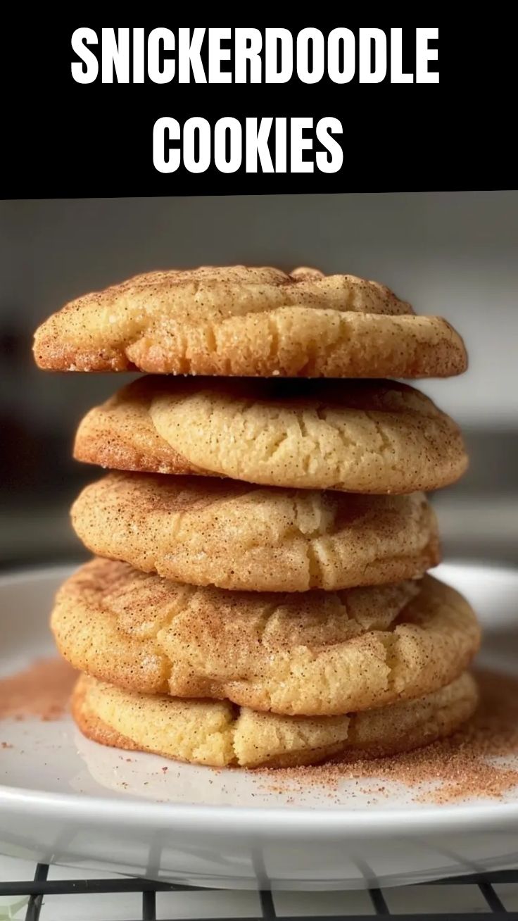 A plate of freshly baked snickerdoodle cookies, warm and crinkled with cinnamon sugar.