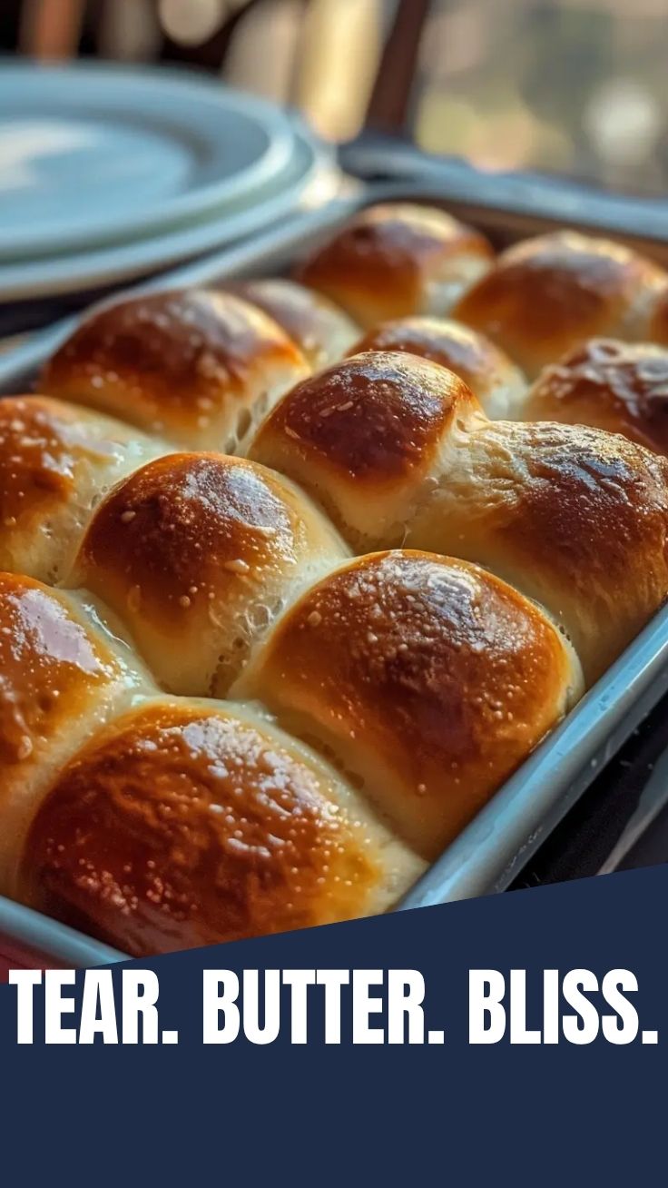 Soft dinner rolls with a golden-brown top, fresh from the oven.