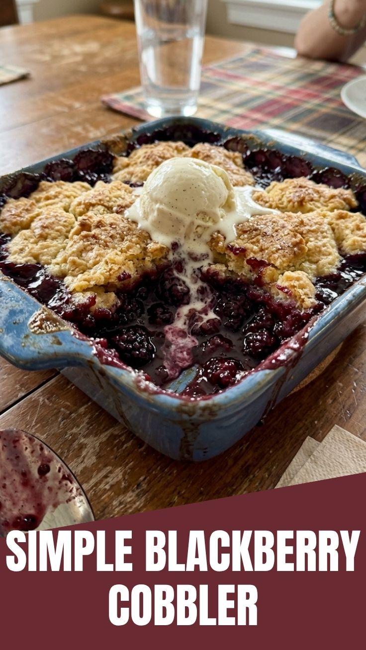 A warm, bubbling blackberry cobbler in a rustic baking dish.