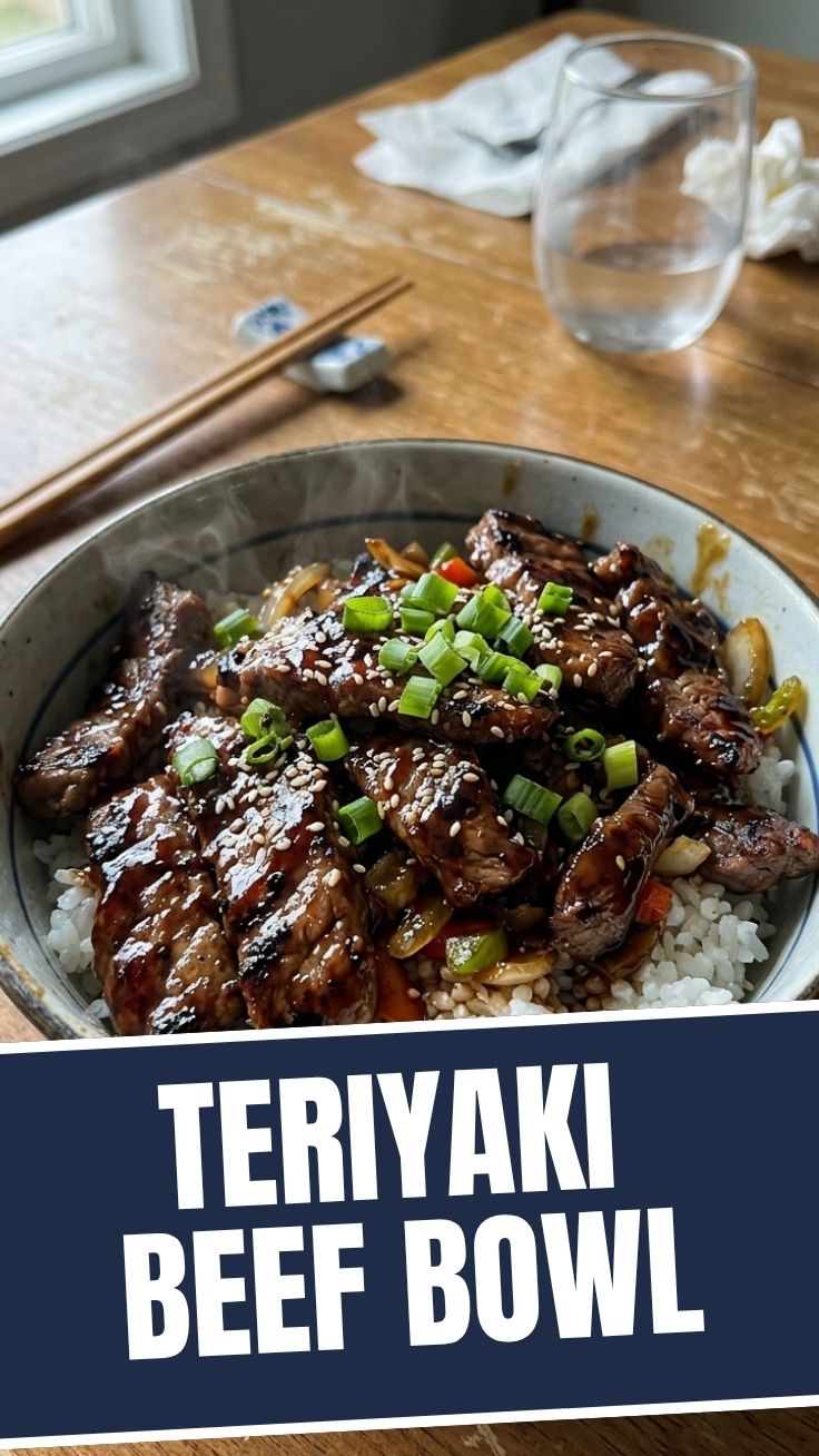A delicious teriyaki beef bowl garnished with sesame seeds and green onions.
