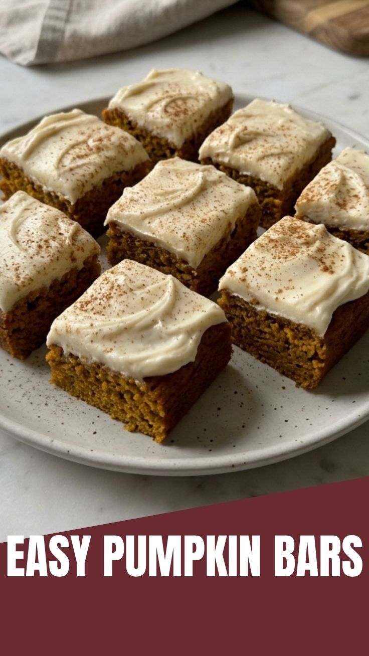 Plate of freshly baked pumpkin bars frosted with cream cheese icing