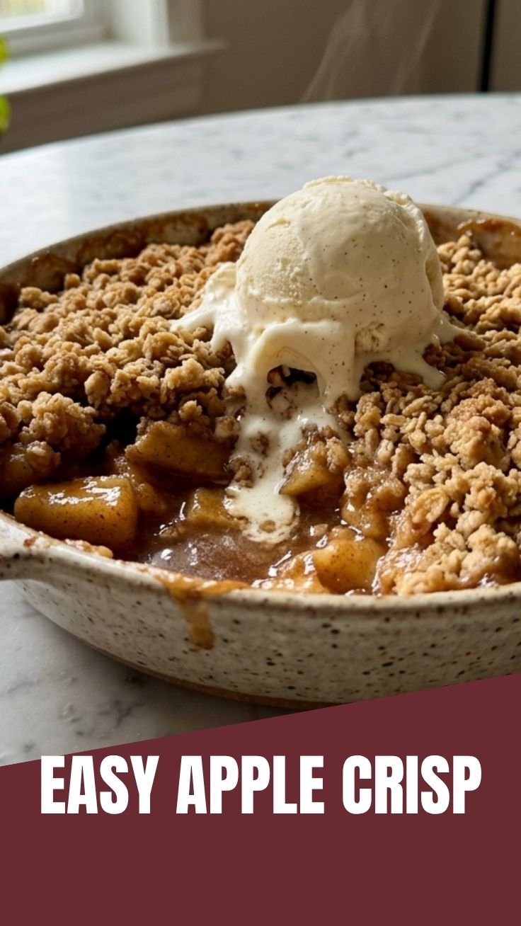 A warm apple crisp with golden-brown topping in a baking dish