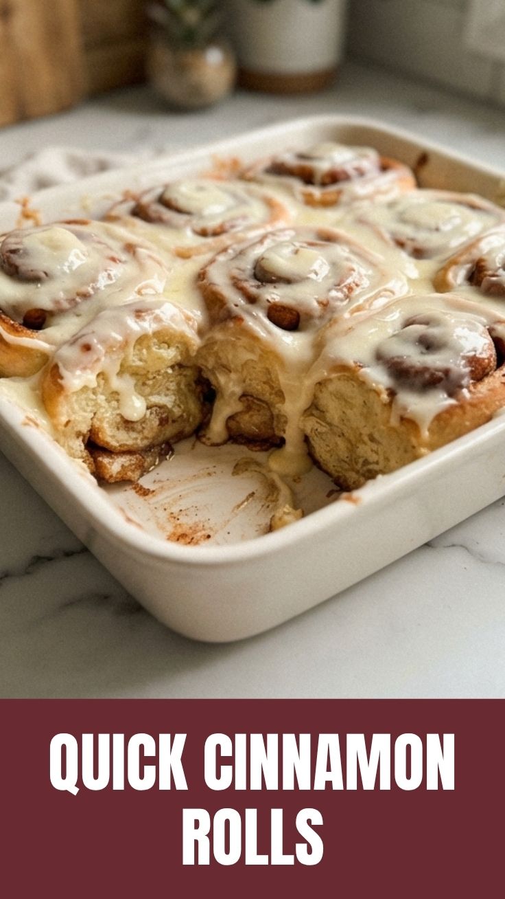 Platter of freshly baked cinnamon rolls with white icing